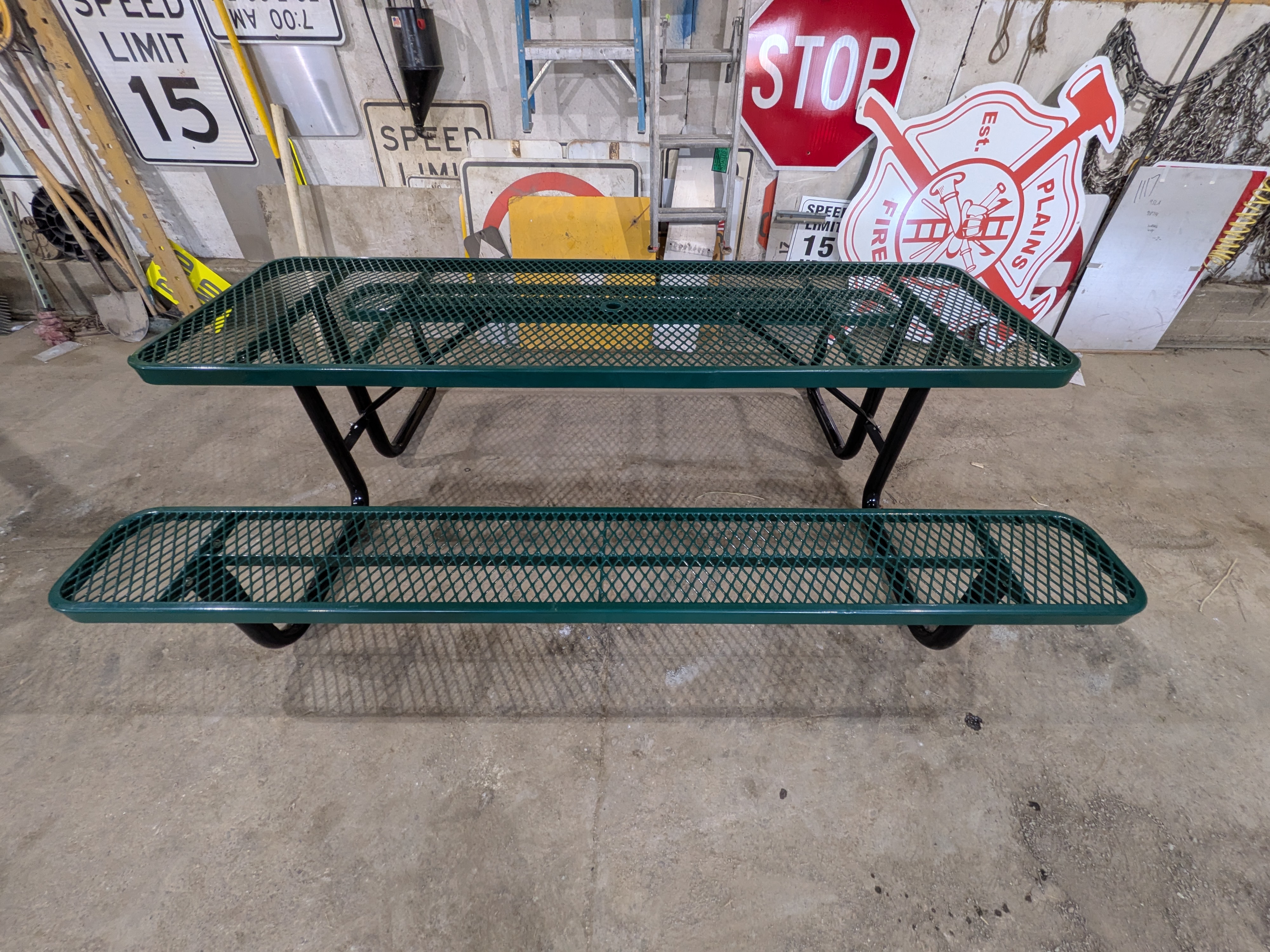 A new green metal picnic table in the town shop