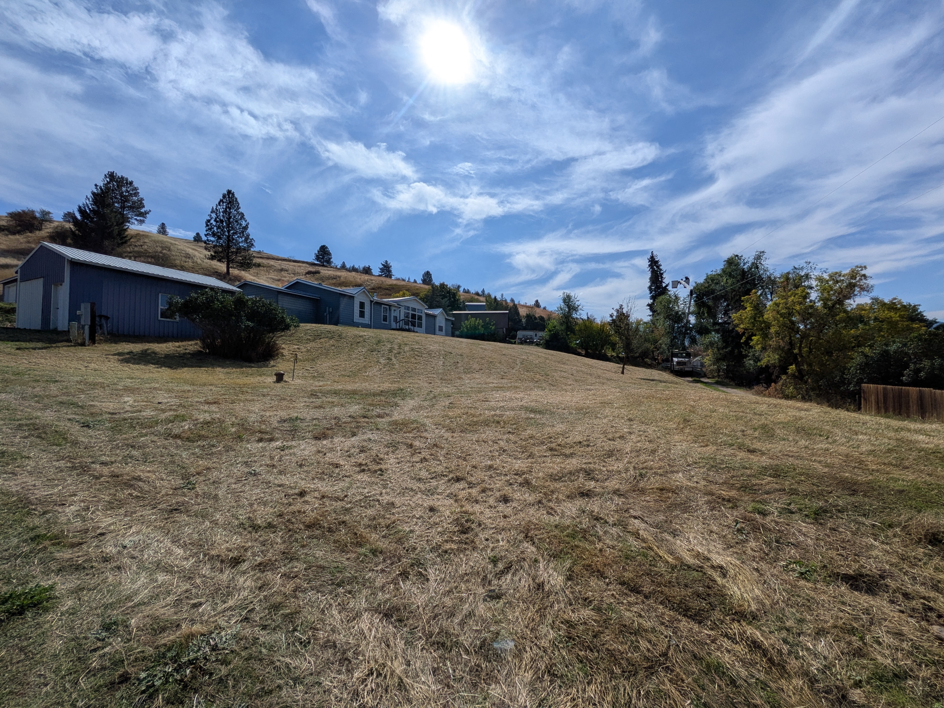 The same yard mowed and raked after cleanup